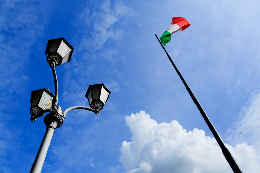 Italian flagpole with street lamp in Cernobbio. Lake of Como, Italy.
